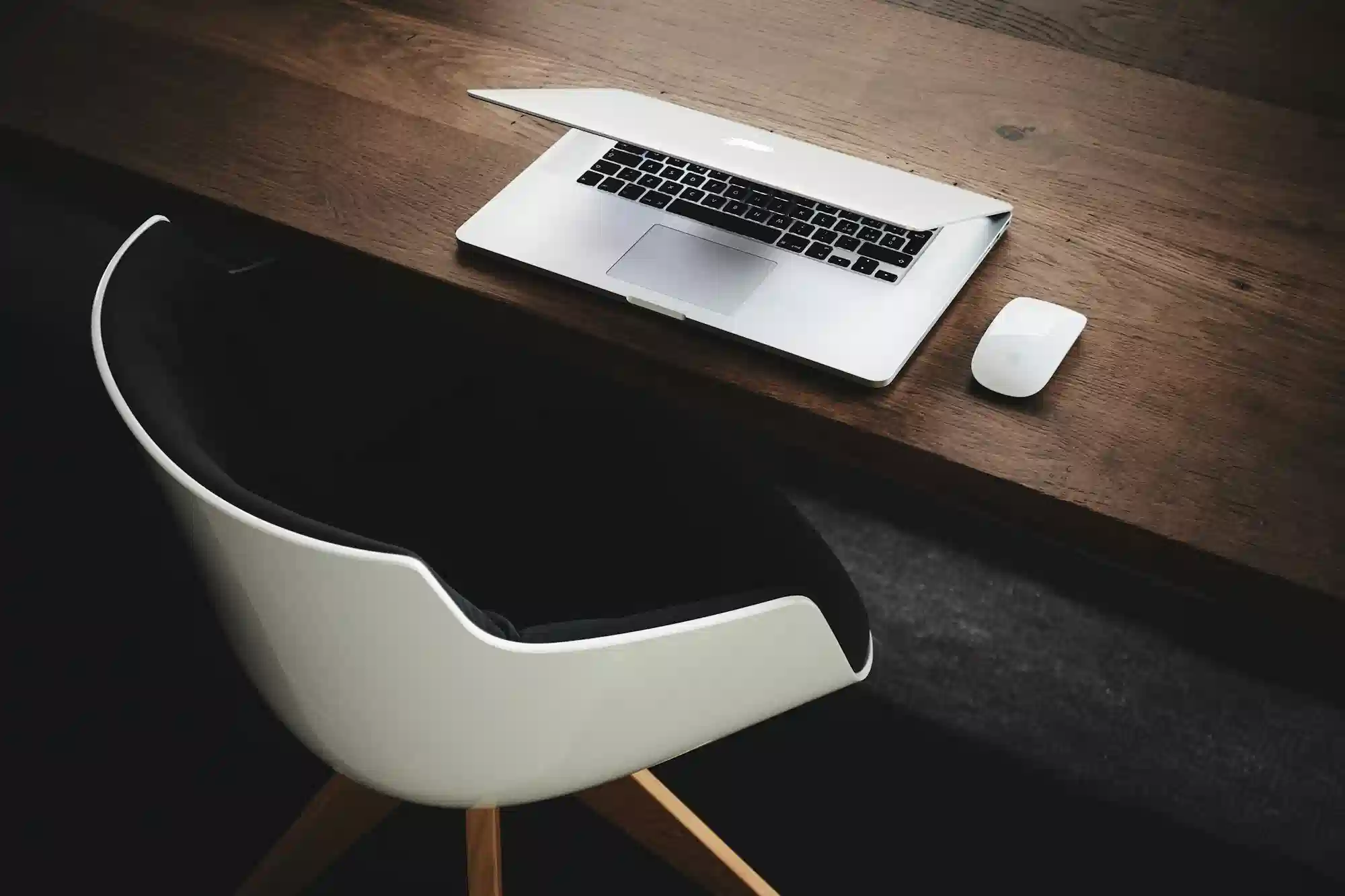 A quiet desk with a laptop open, where most referral conversations actually happen